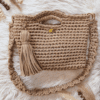 Handcrafted crochet Maxi Bag in a neutral beige tone, made with thick cotton yarn. The bag features a sturdy handle, detachable braided shoulder strap, and an elegant suede tassel. Designed for versatility and style, perfect for casual or dressy occasions.