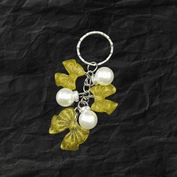 Handmade Golden Petal Resin Keychain with golden petals and pearls, created by Maryam.