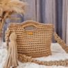 Handcrafted crochet Maxi Bag in a neutral beige tone, made with thick cotton yarn. The bag features a sturdy handle, detachable braided shoulder strap, and an elegant suede tassel. Designed for versatility and style, perfect for casual or dressy occasions.