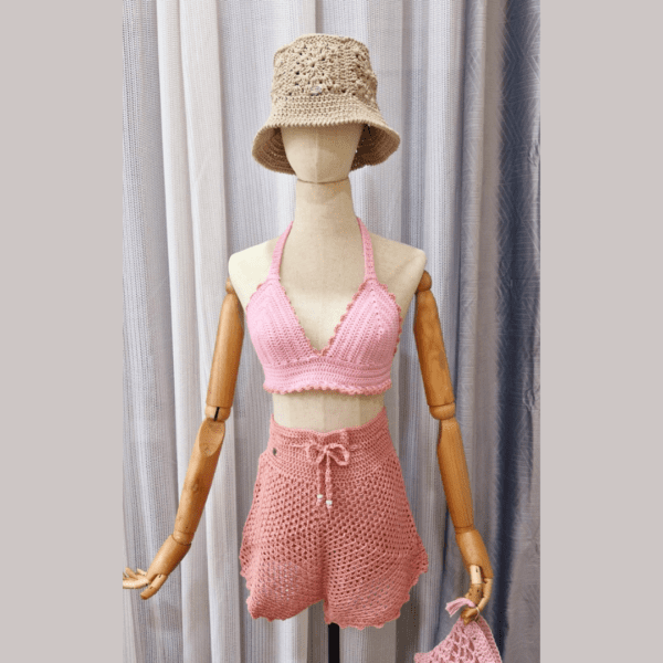 Handmade pink crochet halter top named 'Chanthi Top' by Arty-Crafty by Vanessa, crafted from a mix of cotton and acrylic yarn, featuring adjustable ties and padded design