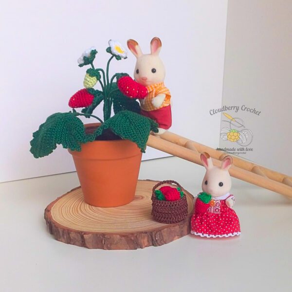 Crocheted strawberry in a clay pot