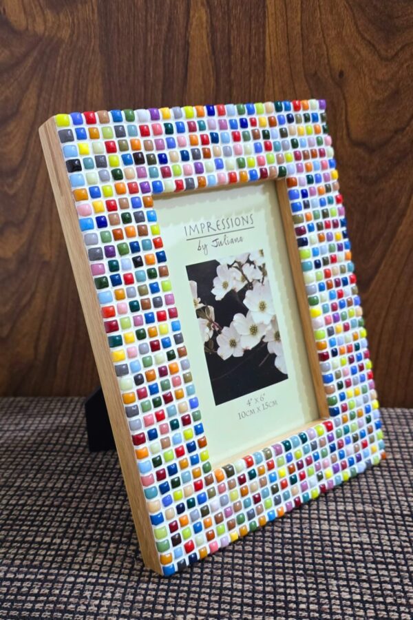 Colorful Rainbow Mosaic Frame displayed on a wooden table, featuring vibrant square tiles in various colors surrounding a 4x6 inch photo. The frame adds a lively and artistic touch to the decor.