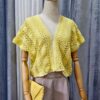 Yellow handmade cotton top named 'Marcella' by Arty-Crafty by Vanessa, featuring a delicate, flowy design with a V-neckline and intricate stitching, displayed on a mannequin