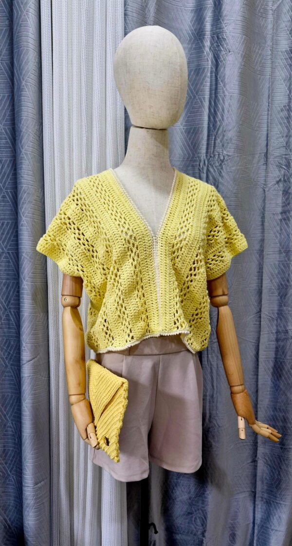 Yellow handmade cotton top named 'Marcella' by Arty-Crafty by Vanessa, featuring a delicate, flowy design with a V-neckline and intricate stitching, displayed on a mannequin