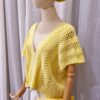 Yellow handmade cotton top named 'Marcella' by Arty-Crafty by Vanessa, featuring a delicate, flowy design with a V-neckline and intricate stitching, displayed on a mannequin