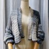 Handmade striped cardigan named 'Isabela Cardigan' by Arty-Crafty by Vanessa, crafted from a blend of cotton and acrylic yarn in shades of gray, featuring a lightweight, free-size design with an open front