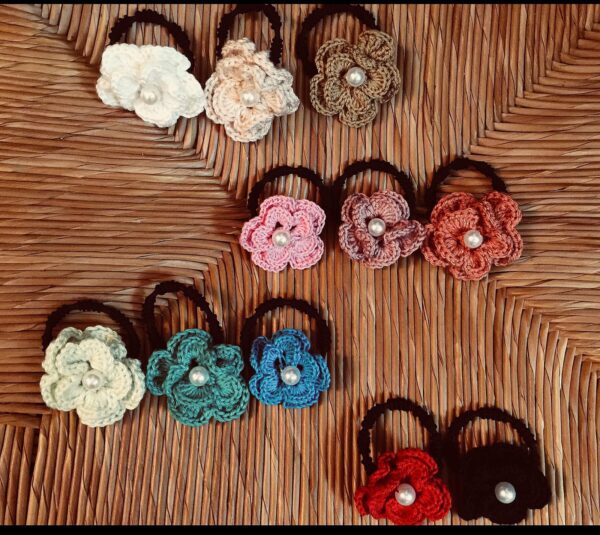 Handmade crochet scrunchies named 'POPPY SCRUNCHIE' by Arty-Crafty by Vanessa, featuring colorful cotton yarn flowers with pearl accents