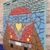 Handcrafted mosaic art titled 'Voxvagan,' depicting a colorful vintage-style car with a yellow heart on the front, made with vibrant glass tiles and detailed craftsmanship