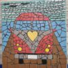 Handcrafted mosaic art titled 'Voxvagan,' depicting a colorful vintage-style car with a yellow heart on the front, made with vibrant glass tiles and detailed craftsmanship