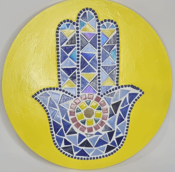 Handcrafted Evil Eye Hamsa Hand Mosaic, featuring a vibrant yellow background and intricate blue and multicolored mosaic tiles forming the protective Hamsa symbol, back of the art