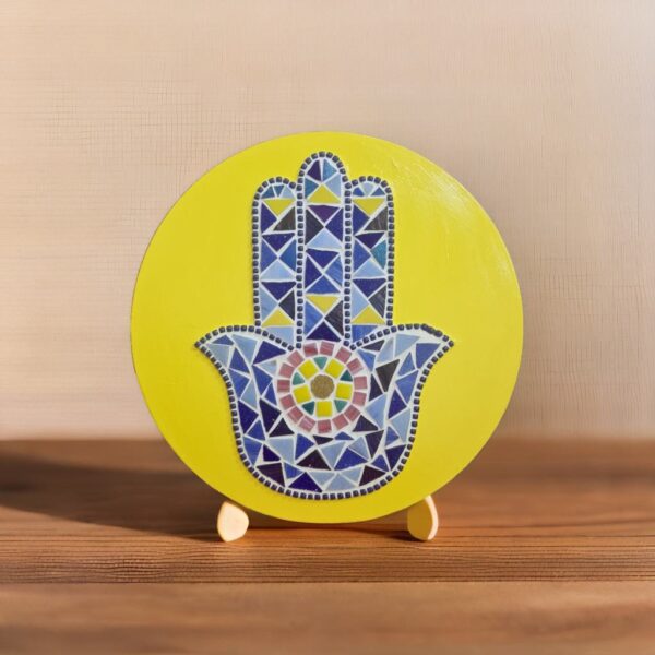 Handcrafted Evil Eye Hamsa Hand Mosaic, featuring a vibrant yellow background and intricate blue and multicolored mosaic tiles forming the protective Hamsa symbol, back of the art