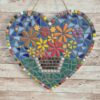 Handcrafted heart-shaped mosaic wall art featuring colorful glass tiles arranged in a vibrant floral pattern, with a basket of flowers at the center. The mosaic is designed with a mix of bright reds, yellows, oranges, blues, greens, and purples, creating a cheerful and lively decoration