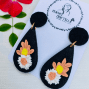 Black teardrop earrings with white, pink, and yellow flowers by Ishara Malshani Settinayake of Peaches Craftella.