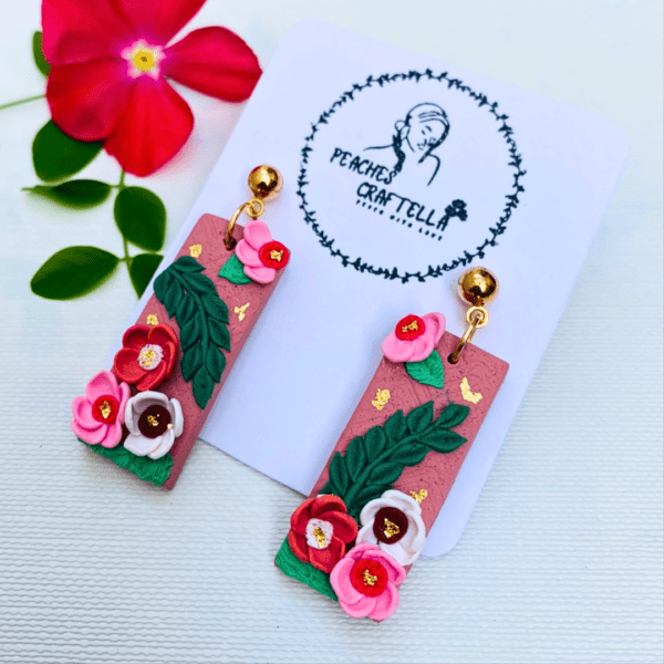 Rectangular earrings with pink roses, green leaves, and gold accents by Ishara Malshani Settinayake of Peaches Craftella.