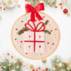 Hand-embroidered wall art featuring a festive Christmas gift, framed in an 8-inch wooden hoop with a red bow, created by Anu Paulson.