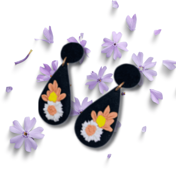 Black teardrop earrings with white, pink, and yellow flowers by Ishara Malshani Settinayake of Peaches Craftella.