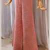 Handmade crochet Charmaine Set in a blush pink tone, featuring a sleeveless crop top and wide-leg pants made from a cotton-acrylic blend. The set is shown on a wooden mannequin with a beige crochet bucket hat, offering a casual yet elegant look.