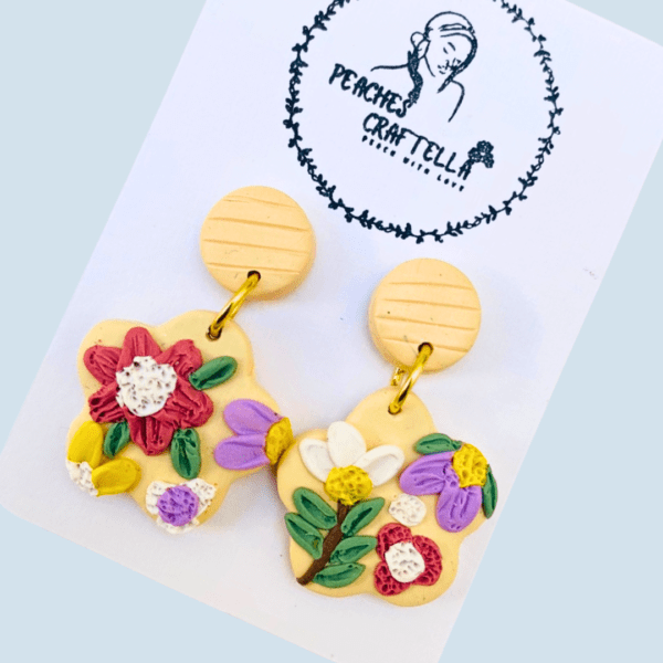 Vintage floral earrings with pink, purple, and green petals on a neutral base by Ishara Malshani Settinayake of Peaches Craftella.