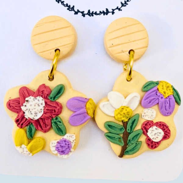 Vintage floral earrings with pink, purple, and green petals on a neutral base by Ishara Malshani Settinayake of Peaches Craftella.