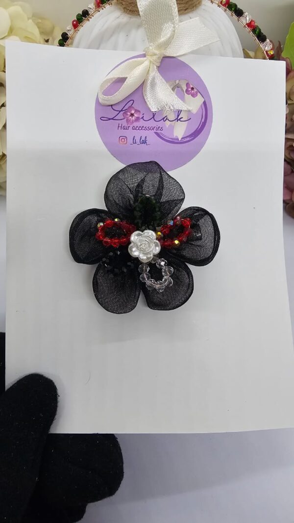 Handmade floral hairband in UAE National colors with black flower and white rose, perfect for kids and special events.