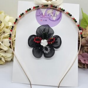 Handmade floral hairband in UAE National colors with black flower and white rose, perfect for kids and special events.