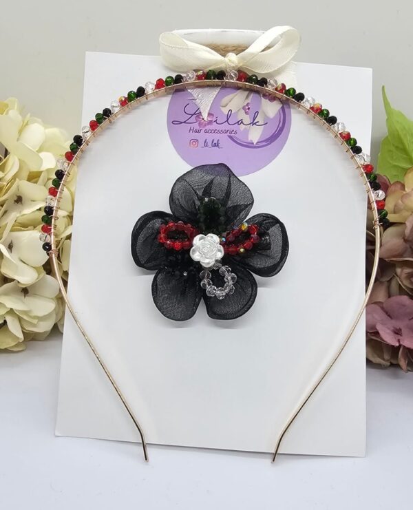 Handmade floral hairband in UAE National colors with black flower and white rose, perfect for kids and special events.