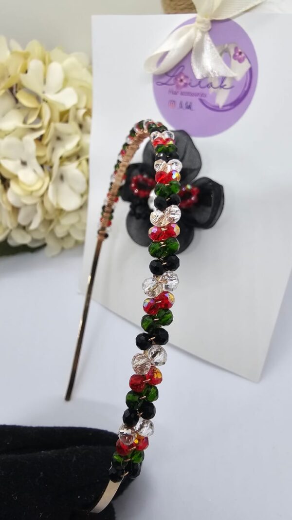 Handmade floral hairband in UAE National colors with black flower and white rose, perfect for kids and special events.