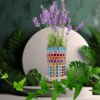 A handcrafted mosaic glass vase featuring colorful glass tiles arranged in vibrant patterns, sealed with white color, and measuring 10x20 cm, perfect for home or office décor.