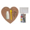 A DIY heart mosaic kit containing a wooden heart template, a bottle of glue, a yellow glue spreader, a twine ribbon, a bag of powdered grout, and a packet of colorful mosaic tiles.