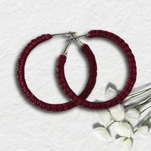 Handmade wine-red macrame earrings in a circular hoop design by Rita Lewis.