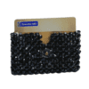 Black beaded credit card holder with snap closure, designed for stylish and secure card storage.