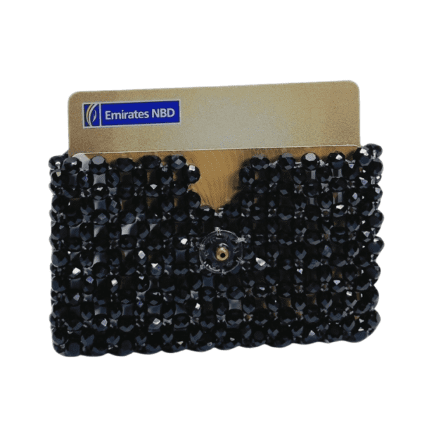 Black beaded credit card holder with snap closure, designed for stylish and secure card storage.