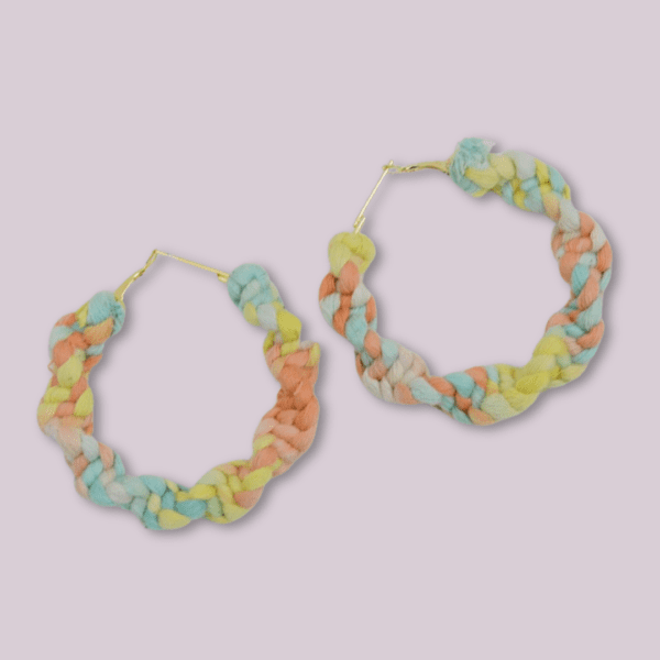 Handmade twisted macrame earrings in pastel Lutino colors (yellow, peach, blue), circular hoop design by Rita Lewis.