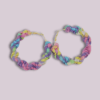 Handmade twisted macrame earrings in unicorn colors (pastel pink, purple, blue, yellow), circular hoop design by Rita Lewis