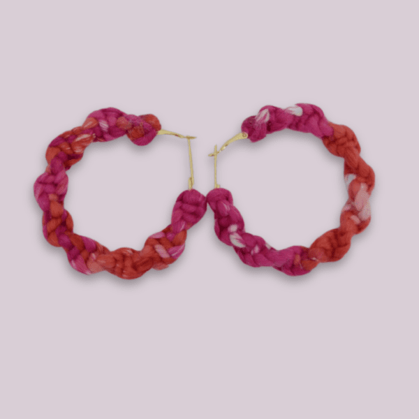 Handmade twisted macrame earrings in Adenium colors (pink and red), circular hoop design by Rita Lewis.