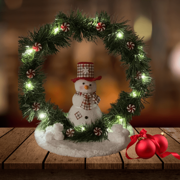 Snowman holiday decoration with LED lights and peppermint accents on a wooden base.