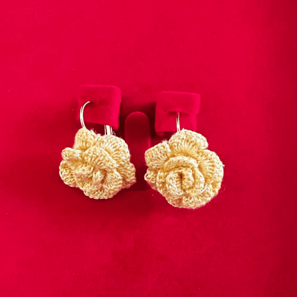 Handmade yellow crochet rose earrings in floral design.