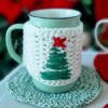 Handmade Blissful Brew Set featuring a crochet mug cover and matching coaster. Customizable colors include blue, red, green, and festive patterns. A perfect gift for tea and coffee lovers.