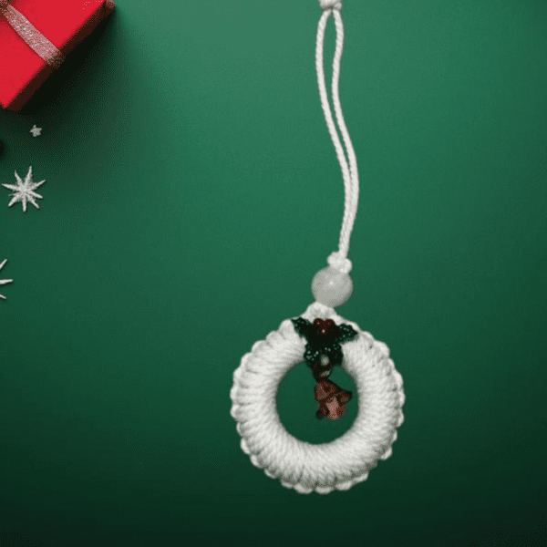 Handmade white macrame Christmas ornament with festive accents, 2.25-inch diameter.