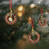 Handmade red and green macrame Christmas ornament with a 2.25-inch diameter, featuring classic holiday colors.