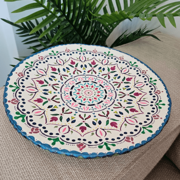 A 26 cm hand-painted Mandala plate featuring vibrant colors and intricate designs, perfect for home decoration or gifting.