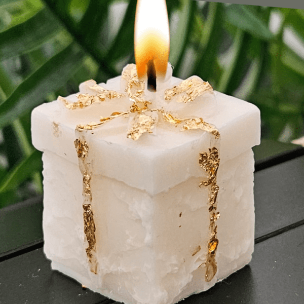 Miniature gift box candle made of soy wax with golden detailing, perfect for gifting or home décor.