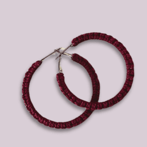 Handmade wine-red macrame earrings in a circular hoop design by Rita Lewis.