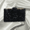 Black beaded credit card holder with snap closure, designed for stylish and secure card storage.