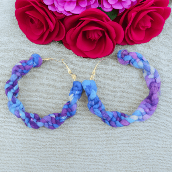 Handmade twisted macrame earrings in cornflower blue and purple tones by Rita Lewis.