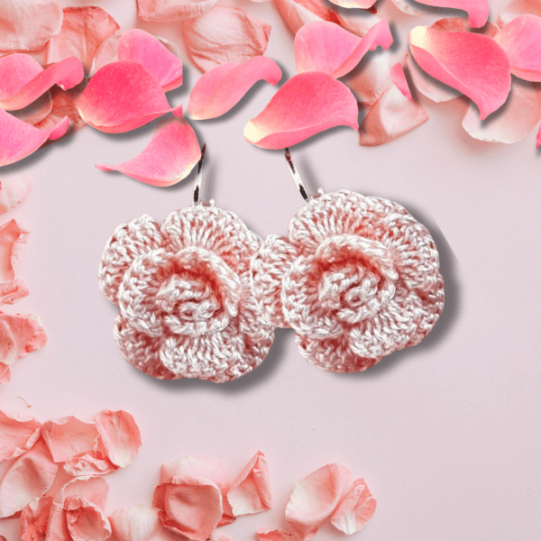 Handmade crochet rose earrings in a soft peach color, floral design.