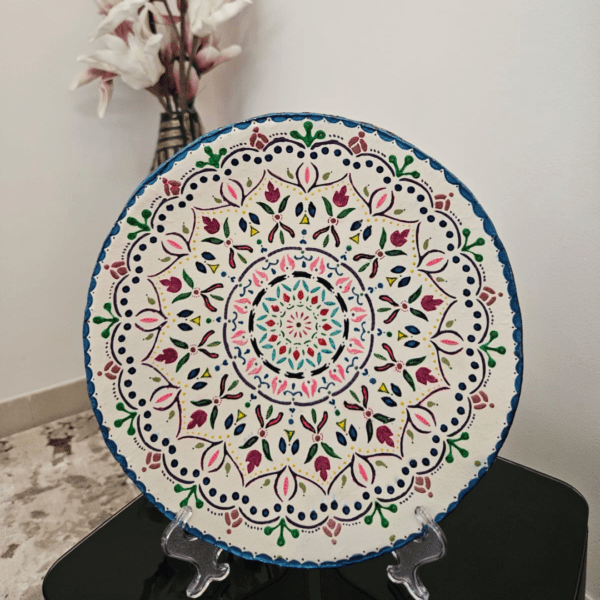 A 26 cm hand-painted Mandala plate featuring vibrant colors and intricate designs, perfect for home decoration or gifting.