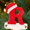 Personalized initial ornaments with Santa hats for Christmas tree decorations.