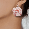 Handmade crochet rose earrings in a soft peach color, floral design.