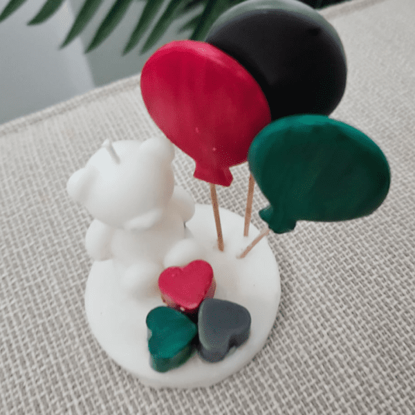 Bear-shaped soy wax candle with balloons and hearts in UAE flag colors, perfect for UAE National Day celebrations.